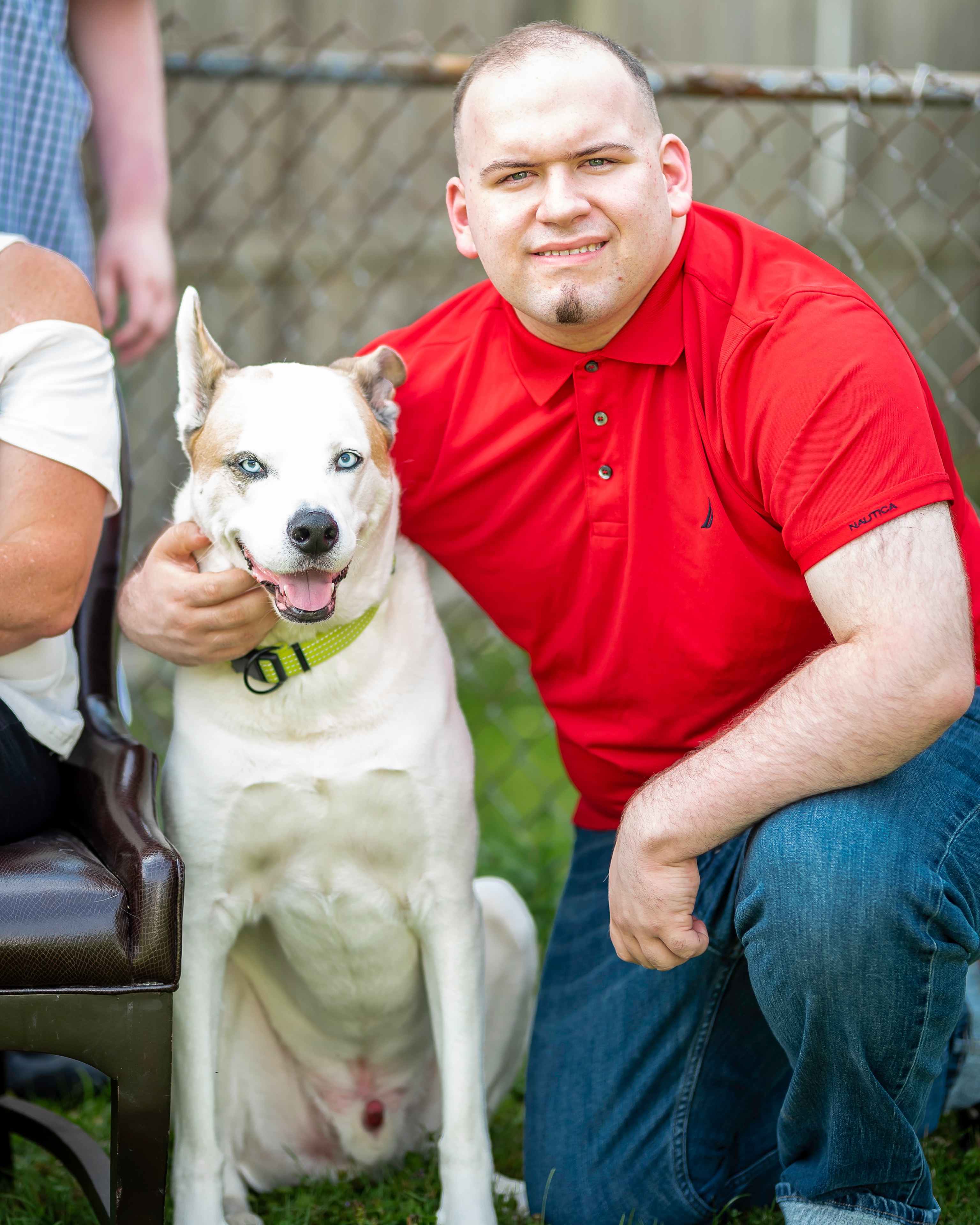 Family moment with their white dog in the backyard